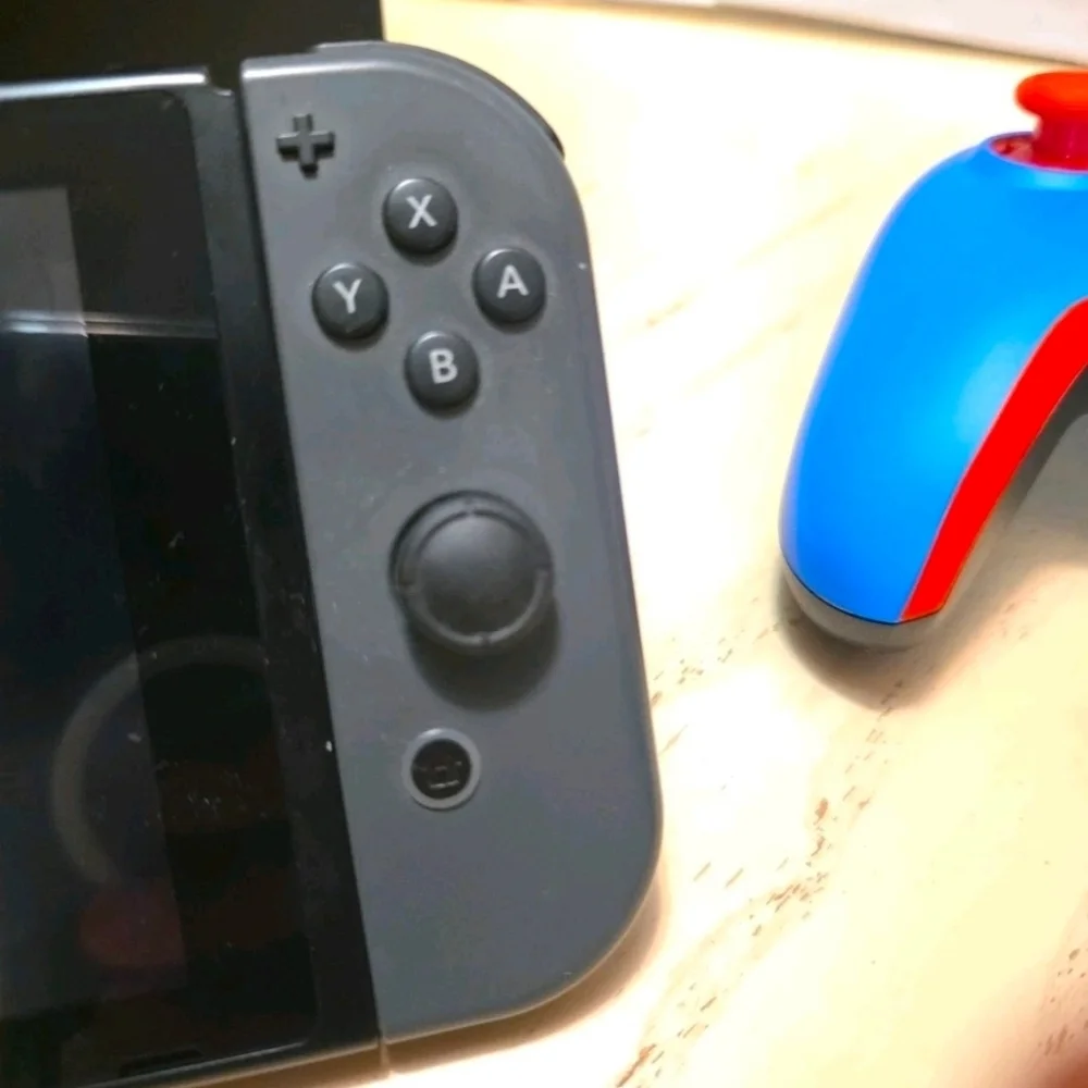 Nintendo Switch with Black Pro Controller and Blue Red Wired Controller